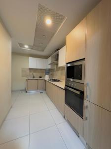 a large kitchen with a stove and a microwave at One Bedroom apartment Centaurus Islamabad in Islamabad