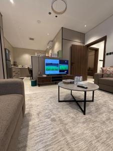 a living room with a couch and a coffee table at شقة البدر in Medina