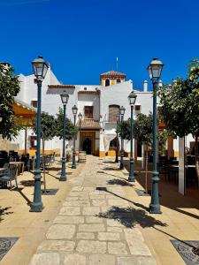 a row of lights on a sidewalk in front of a building at Posada de Jose Mª El Tempranillo in Alameda