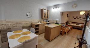 a kitchen and a living room with a table and chairs at Willa Gracja in Wisła