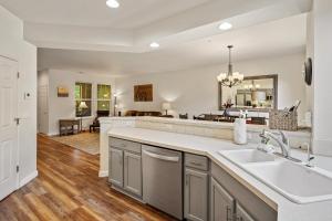 a kitchen with a sink and a living room at Old Mill Magic in Bend