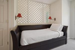 a bed in a bedroom with two lamps and a window at Old Mill Magic in Bend