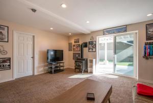 a living room with a tv and a door at Northern Daylights in White Salmon