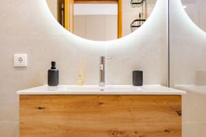 a bathroom with a sink and a mirror at JPL - Preces Residential in Câmara de Lobos +30 photos