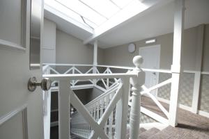 a room with a door and a staircase with a skylight at Ambassador Hotel in Glasgow