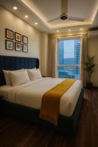 a bedroom with a large bed with a large window at Guest Nest Executive Stay- Elysium Tower Opposite Centaurus Mall Islamabad in Islamabad +131 photos