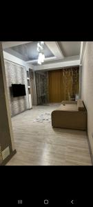 a large room with a bed in the middle of it at Раззаков in Bishkek +4 photos