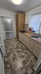 a kitchen with a sink and a counter top at Garsoniera in Craiova