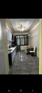 a large kitchen with a table and chairs in it at Раззаков in Bishkek