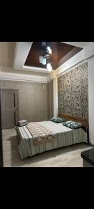 a bedroom with a large bed in a room at Раззаков in Bishkek
