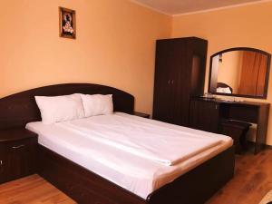 Postel nebo postele na pokoji v ubytování Pensiunea Roma MD + 2 fotografie