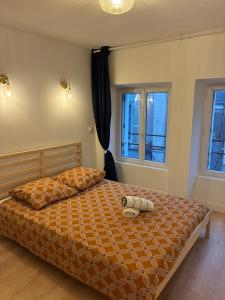 a bedroom with a bed and two windows at Appartement chic & cosy - 6 couchages Angers in Angers