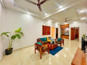 a living room with a couch and a table at PALM GROVE By D2V in Cochin