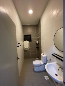 a bathroom with a toilet and a sink at TF Homestay in Banting