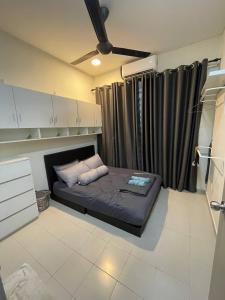 a small bed in a room with a ceiling at TF Homestay in Banting