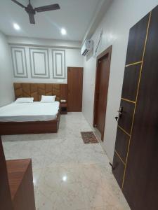 RāmnagarThe Holiday Inn的一间卧室配有一张床,一扇门通往一个房间