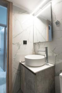 a white bathroom with a sink and a mirror at Serra Modern Apt " Free Parking " Quiet " Near Center in Serres