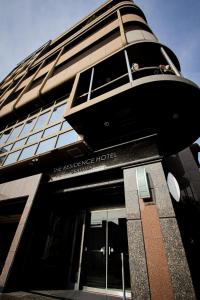 a building with a sign that reads the excellence hotel at ザレジデンスホテル岡山 in Okayama