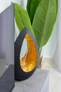 a vase with a mirror on top of a table at Serra Modern Apt " Free Parking " Quiet " Near Center in Serres