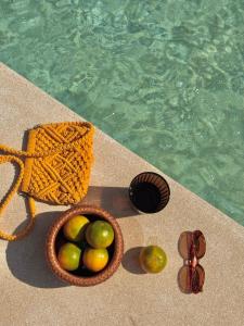 a basket of fruit next to a swimming pool at Las Tortugas beach front condo in Khao Tao
