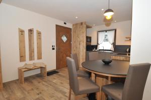 a kitchen and dining room with a table and chairs at Borch Chalet - Exclusive Apartments in Livigno