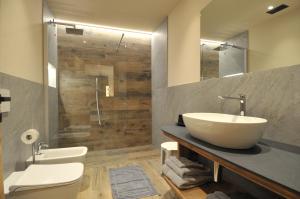 a bathroom with a sink and a toilet and a shower at Borch Chalet - Exclusive Apartments in Livigno +11 photos