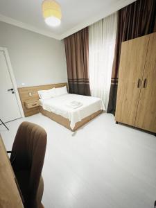 a bedroom with a bed and a chair in it at Karhal Room in Edirne +7 photos