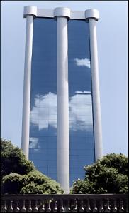 a reflection of a building with three pillars at Diamond Hotel in Rio de Janeiro