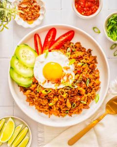 a plate of fried rice with an egg on top at Hotel Star Plaza - 1 Minute From New Delhi Railway Station & Connaught Place in New Delhi