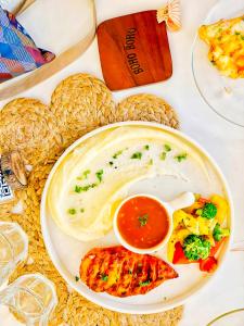 a plate of food with meat and vegetables on a table at Hotel Star Plaza - 1 Minute From New Delhi Railway Station & Connaught Place in New Delhi