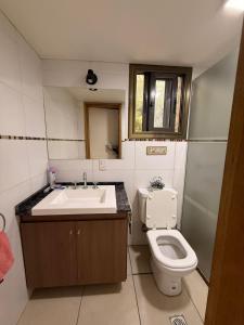 a bathroom with a sink and a toilet at Las Marias in San Rafael