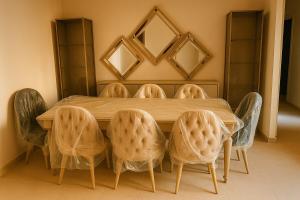 a dining room with a wooden table and chairs at Cairo Airport Oasis Cozy Convenient in Obour
