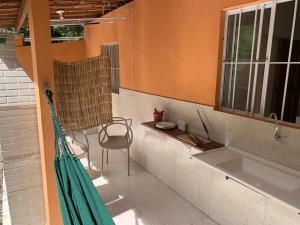 a kitchen with a sink and a chair and a window at CASA da CHi in Piranhas +58 photos