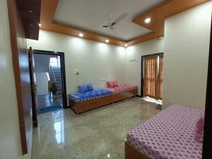a room with two beds and a mirror at Swami Bhakt Nivas in Tuljapur