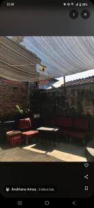 a room with a table and two red chairs and a table and a table at Penginapan SALSA in Ketapang +6 photos