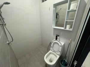 a small bathroom with a toilet and a window at Princeton Suite @Kuching Airport in Kuching +55 photos
