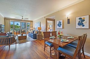 a dining room and living room with a table and chairs at Honua Kai Konea 206 in Lahaina