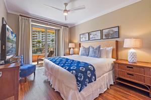 a bedroom with a large bed and a television at Honua Kai Konea 206 in Lahaina +57 photos