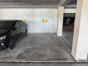 a small car parked in a parking garage at Princeton Suite @Kuching Airport in Kuching