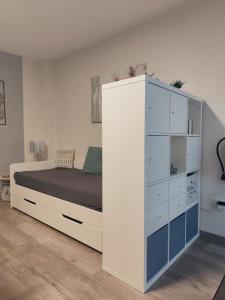 a bedroom with a bed and a white cabinet at Ferienwohnung Bamberger mit Wintergarten Schmalkalden in Schmalkalden
