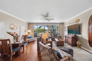 a living room with a table and a dining room at Honua Kai Konea 204 in Lahaina