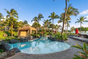 a resort pool with palm trees and a gazebo at Honua Kai Konea 204 in Lahaina