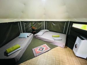 a couple of beds in a tent at Anatolia Retreat in Bentong