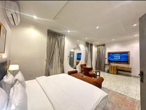 a hotel room with a bed and a tv at Bricks Residence in Lekki