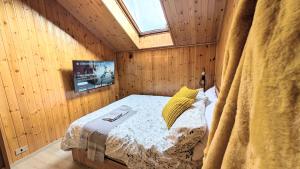 Un dormitorio con una cama en una habitación de madera. en Apartments in the woods, en Pila