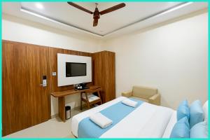 a hotel room with a bed and a television at Hotel Shri RK Residency Near Kashi Vishwanath Temple - Fully Air Conditioning Rooms - Restaurant-Lift and Free Wifi Facilities- Top Rated Hotel In Varanasi in Kashi