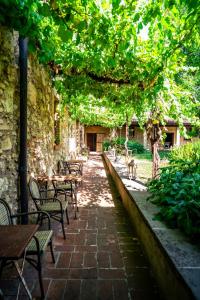 an outdoor patio with tables and chairs and trees at Cappuccini Resort in Cologne