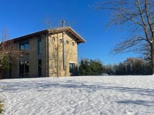 a building in the snow in front of a building at CA' SAN LUISS in Cerretto Langhe