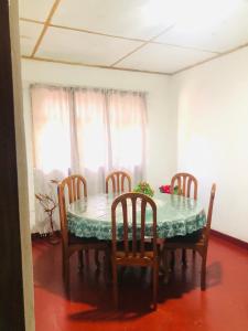 a dining room table with chairs and a table and a table and chairsktop at Villa Elora in Bandarawela