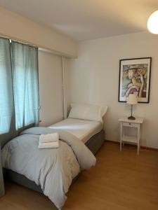 two beds in a small room with a window at Hostel City Basel 389 in Basel +12 photos